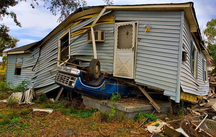 House on top of overturned car after hurricane