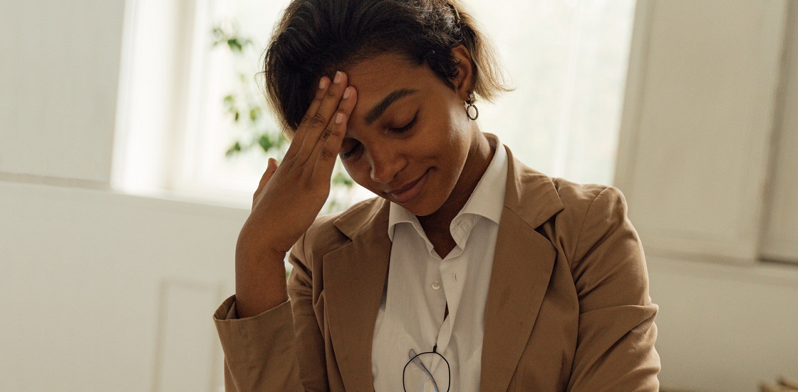 stressed female teacher rubbing forehead