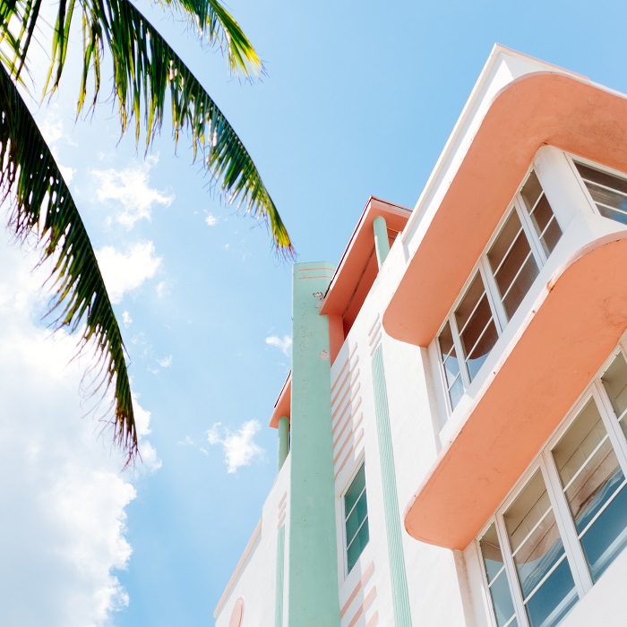 View towards sky of pastel house and tree in Miami, Florida