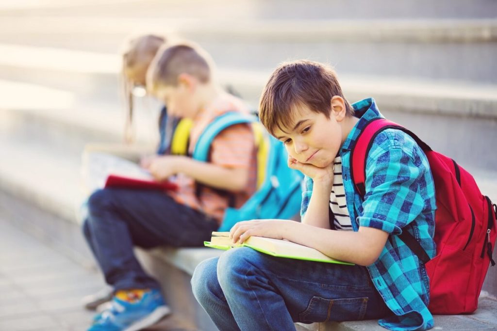 school kids sitting outside