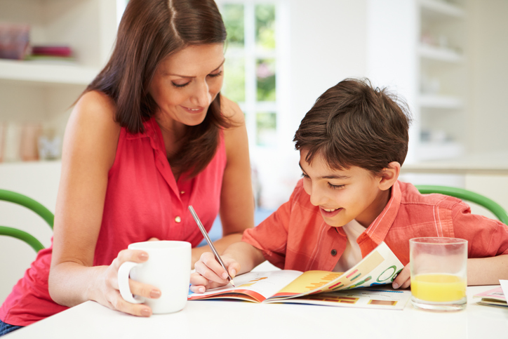 Woman helping child with homework