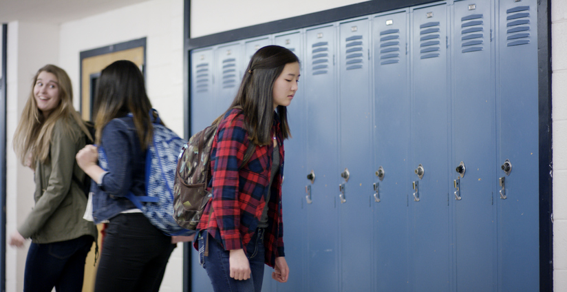 Teenage girl looking sad at school