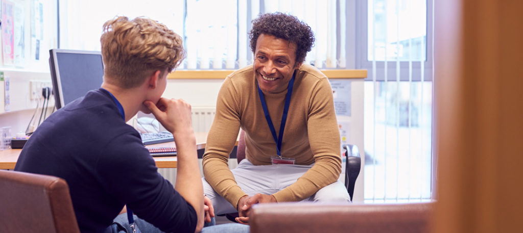 teacher having private conversation with student about trauma they experienced