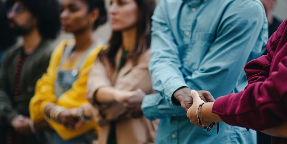 People holding hands in line