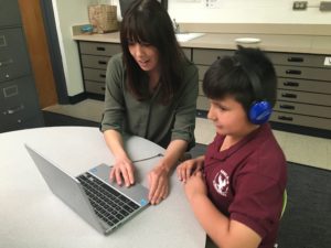 Tracy Shellooe teaching special education student on laptop