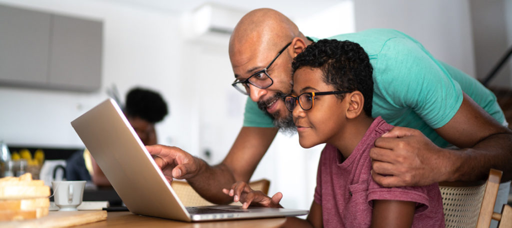 Father and son looking at laptop