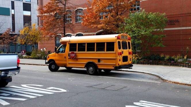 Yellow public school bus on the road in New York City