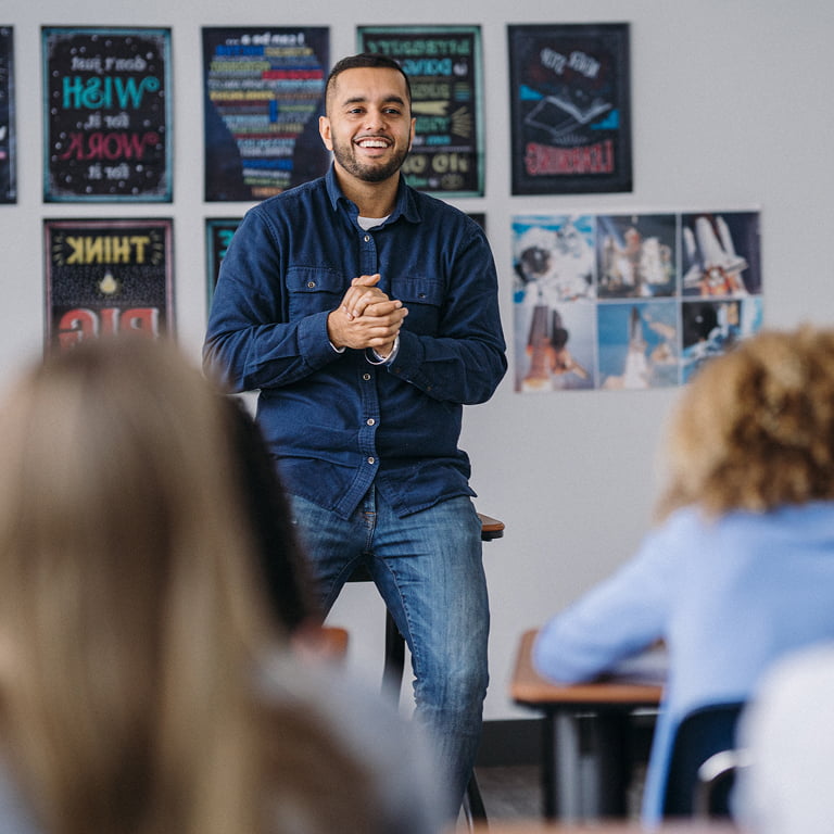 Male Hispanic teacher teaching wellness skills to middle school students