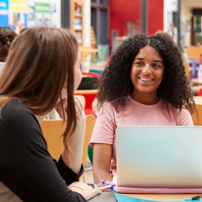 Female students working together on future skills in college campus