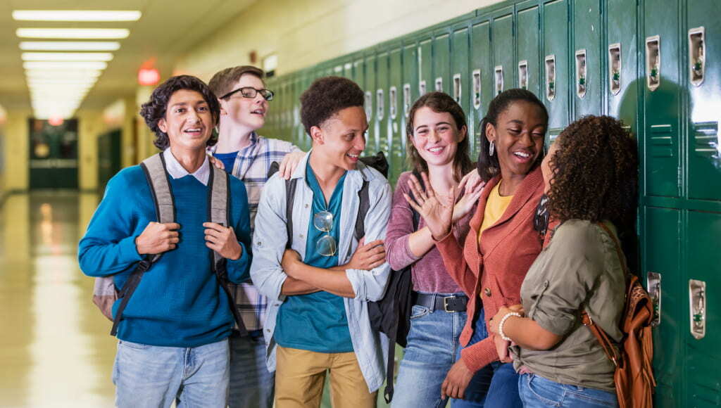 Multi ethnic high school students hanging out in hallway