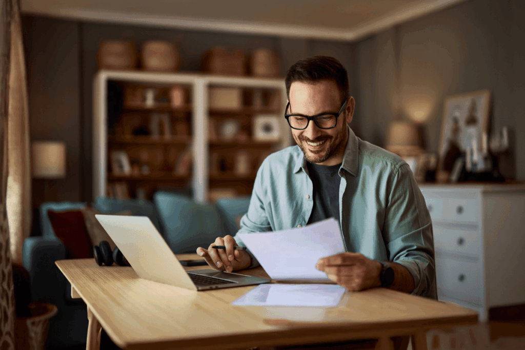 Educator reviewing documents while working at home desk