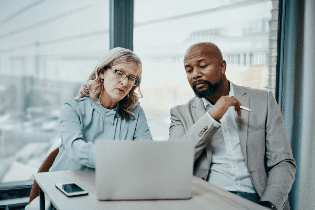 Education leaders analyzing MTSS data on a laptop to strengthen strategic decision making.